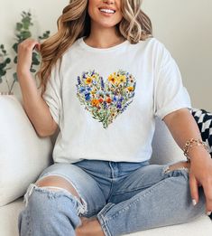 This is the PERFECT gift for the person in your life (including yourself!) that LOVES flowers! We print & ship our products from within USA. The perfect gift for Christmas, Birthdays, Holidays & Anniversaries! We use Gildan 5000 tees made from 100% soft cotton. Super comfy & great for those with sensitive skin. Runs true to size. For example, if you would usually wear a Medium, then a Medium in our tee will fit great. We offer Size Small through to 5XL. Unisex cut that looks & feels great on all Spring Heart Graphic Tee, Spring Heart-shaped Graphic Tee, Spring Printed Tops For Gift, Printed Tops For Spring Gift, Printed Tops For Spring, Spring Graphic Print Tops Gift, Spring Graphic Print Tops As Gift, Graphic Print Tops As Spring Gift, Graphic Print Tops For Spring Gift