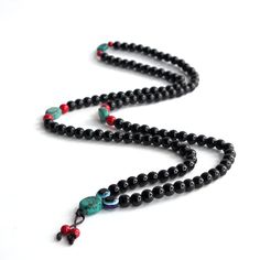 Obsidian Mala Necklace - 108 Beads Mala with Turquoise Tassel. Obsidian is a gemstone that signifies Balance and Positivity. It improves our thinking patterns by removing the negativity from within and around us. It helps us in achieving the balance. Mala Length - 20 inches appx  Obsidian Bead Size - 8 - 8.5 mm  108 + 1 bead for meditation  Please note that as Gemstones are Natural Gifts of nature, the pattern, clarity, and color on them might vary depending from lot to lot. If you want to get something custom-made, or if you need more no of strands, please feel free to leave a message. We cater to bulk/wholesale requirements as well. I will be very happy to answer your queries. Thank you! Package Detail 1 x Obsidian Mala 1 x Prayer Flag 1 x Hemp Mala Bag Or Pouch  1 x Incense Black Handmade Beaded Necklaces For Healing, Handmade Black Beaded Necklaces For Healing, Black Beaded Necklaces With 8mm Beads, Black Beaded Necklaces With 8mm Round Beads, Handmade Black Mala As Gift, Black Beaded Bracelet With 108 Beads For Meditation, Spiritual Black Beaded Necklaces With Round Beads, Black Bohemian Beaded Bracelets With Gemstone Beads, Onyx 8mm Beaded Necklaces For Jewelry Making