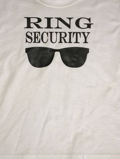 a white t - shirt with the words ring security printed on it and black sunglasses