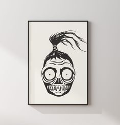 a black and white drawing of a skull with hair on it's head in a frame