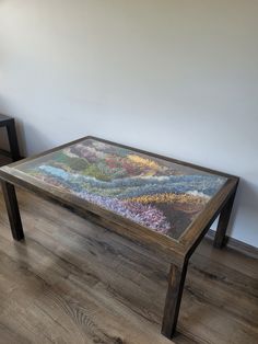 a glass table with flowers painted on it