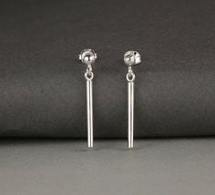 Minimal earrings. Simple stud and hanging post earrings.Sterling silver.2.9cm high.5% of all profits go the the charity Help Refugees.Also in these photos is my Silver Pebble Bracelet:https://www.etsy.com/uk/listing/580286451/winter-gift-wife-minimal-bracelet?ref=shop_home_active_1 Minimalist Dangle Plug Earrings As Gift, Silver Minimalist Dangle Plug Earrings, Minimalist Hypoallergenic Dangle Plug Earrings, Minimalist Dangle Plug Earrings, Minimalist Nickel-free Dangle Plug Earrings, Minimalist Dangle Plug Earrings With Matching Pair, Minimalist Nickel-free Drop Plug Earrings, Minimalist Hypoallergenic Drop Plug Earrings, Minimalist Hypoallergenic Drop Earrings