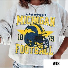 Perfect sweatshirt for Michigan football fans this season! Ideal for any situation, a unisex heavy blend crewneck sweatshirt is pure comfort. These garments are made from polyester and cotton. This combination helps designs come out looking fresh and beautiful. The collar is ribbed knit, so it retains its shape even after washing. There are no itchy side seams on these sweaters.  .: 50% cotton, 50% polyester .: Medium-heavy fabric (8.0 oz/yd² (271.25 g/m .: Loose fit .: Sewn-in label .: Runs tru Heat Press Printing, Football Vintage, Michigan Football, Football Sweatshirt, Vintage Football, Football Fans, Looks Vintage, Unisex Sweatshirt, Clothing Items