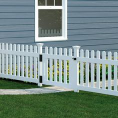 a white picket fence in front of a house