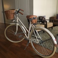 a white bicycle parked in front of a living room door