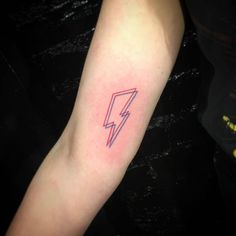 a person with a tattoo on their arm has a lightning bolt in the middle of his arm