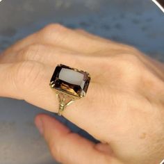 This is a marvellous classic ring from England with a royal look to it. A lush chocolate smoky quartz ring in 9k yellow gold from the 1960s. In very nice vintage condition with only a little wear on the stone and no scratches or chips.  The setting is supported by gold latticework and a marcasite effect in gold on the band. Ring size is 8.0 US, and the stone is about 25mm long and 10mm wide and roughly 5mm deep, with a total weight is 5.0 grams. Hallmarks on the inside of the band include 375 (f Antique Brown Rings For Anniversary, Brown Gemstone Rings In 14k Gold, Fine Jewelry 14k Gold Brown Ring, Brown 14k Gold Fine Jewelry Ring, Brown 14k Gold Rings Fine Jewelry, 14k Gold Brown Gemstone Jewelry, 14k Gold Jewelry With Brown Gemstones, Brown 14k Gold Gemstone Jewelry, Brown 14k Gold Jewelry With Gemstones