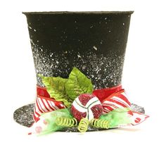 a top hat decorated with candy canes and green leafy decorations on white background