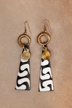 Designed for pierced ears, the Brass Earrings featuring African print details are shaped as a long drop. The intricate golden details at the hook can lend your attire a modern feel, without compromising on the African heritage. Never a dull moment or a dull outfit when choosing to wear the Brass Earrings with this special shape and design. They are best paired with an all-white outfit or with a white blouse, t-shirt or caftan as this color can emphasize their special characteristics even more. G Dull Outfit, Dope Jewelry Accessories, African Earrings, African Necklace, African Heritage, Polymer Clay Jewelry Diy, Dope Jewelry, Clay Jewelry Diy, White Outfit