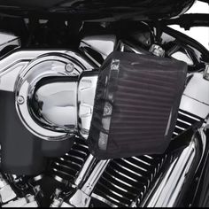 a close up of a motorcycle engine with the air filter on it's side