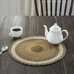 a wooden table topped with a white tea pot