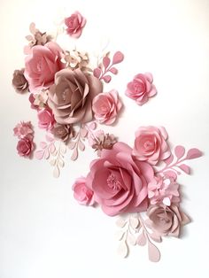 paper flowers are arranged on a white surface