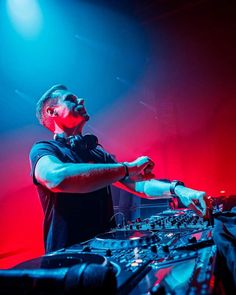 a man in black shirt djing at a concert