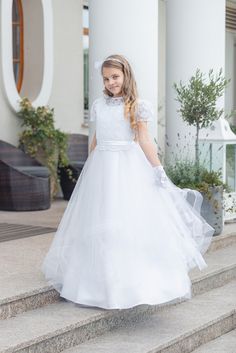 Hello! Thank you for your interest in the SUSSANE Girls' Communion Dress. Allow me to describe this exceptional product that will provide your daughter with an unforgettable experience on her First Holy Communion day. The SUSSANE Girls' Communion Dress is a perfect blend of sophistication and elegance. This unique dress is designed to make your little princess feel like a true angel on her special day of First Holy Communion. The carefully crafted embellishments on the top of the dress add a tou Short Sleeve Ruffled Dress For Confirmation, White Short Sleeve First Communion Dress With Ruffles, White First Communion Dress With Ruffles And Short Sleeves, Fitted Ruffle Dress For Confirmation, Fitted Ruffled Dress For Confirmation, Fitted Ruffle Dress For First Communion, Fitted Short Sleeve Gown For Confirmation, Fitted Gown With Short Sleeves For Confirmation, Girls Communion Dresses