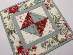 a close up of a quilted table topper