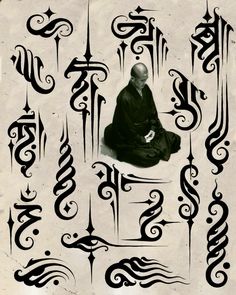 a man sitting on top of a white floor covered in calligraphy letters and symbols