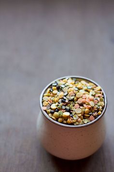 a small bowl filled with seeds on top of a wooden table