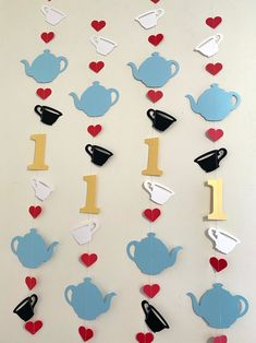 teapots, cups and hearts are hanging on the wall with numbers 1 - 10