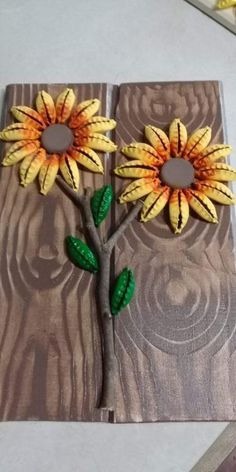 an art project made out of wood with sunflowers on it