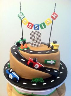 a birthday cake is decorated with cars and the number nine on it's side