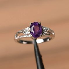 It is a natural amethyst ring. The main stone is 6 mm*8 mm oval cut.weight about 1.14 carats. The basic metal is sterling silver and plated with rhodium. To change the metal to a solid gold (white/rose) or platinum is also available, please ask for a quotation if you want. You can also go to my shop Home for more elegant rings: https://www.etsy.com/shop/godjewelry?ref=hdr_shop_menu Amethyst is the February birthstone . More amethyst rings: https://www.etsy.com/shop/godjewelry?section_id=20709248 J Ring, Handfasting Ceremony, Amethyst Rings, Elegant Rings, Purple Ring, Amethyst Ring Engagement, Purple Amethyst Ring, Ring Purple, London Blue Topaz Ring