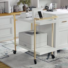 a computer desk with drawers and a phone on top