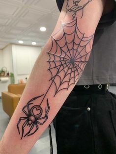 a person with a spider web tattoo on their arm