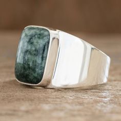 This prominent men's ring is the design of Zandra Lorena Sajbin. The wide high-polished band crafted of sterling silver features a bold rectangular stone of green Guatemalan jade. This ring will surely catch everyone's eyes. Single Stone Ring, Jade Ring, Single Stone, Mens Ring, Men's Ring, Green Jade, Jade Green, Stone Ring, Statement Ring