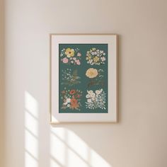 a framed floral print hangs on the wall