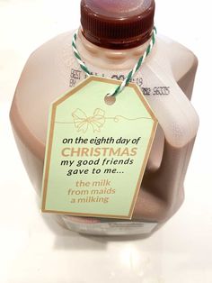 a bottle of milk with a tag attached to it that says on the eighth day of christmas, my good friends gave to me