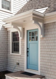 a blue front door on a white house