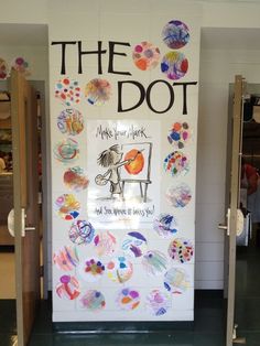 the door is decorated with many different colored paper circles and words that read, the dot make your mark and do what we have to say you