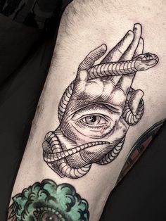 a man's leg with an all seeing eye tattoo on it