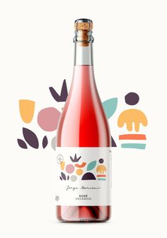 a bottle of rose wine on a white background with colorful leaves and shapes around it