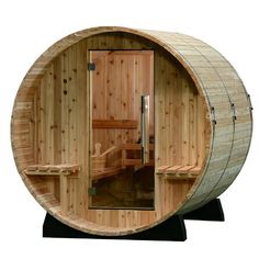 a wooden barrel sauna is shown with the door open