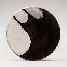 a black and white plate sitting on top of a table