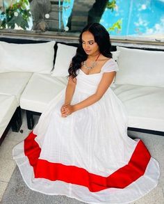 This Habesha Kemis is a true work of art, featuring a radiant red design at the bottom that adds a pop of color and texture to the dress. The crimson color of the design is bold and striking, creating a beautiful contrast with the rest of the dress. The Habesha Kemis design is simple yet elegant, with a flowing skirt and a fitted bodice that is both comfortable and flattering. The dress is made from high-quality materials, with soft and breathable fabric that feels comfortable against the skin. Red Anarkali Gown For Traditional Ceremonies, Traditional Red Floor-length Dress, Red Dress For Navratri Traditional Ceremonies, Red Maxi Gown With Pallu, Traditional Red Maxi Length Dresses, Red Maxi Length Gown With Pallu, Red Fitted Gown For Festivals, Fitted Red Gown For Festivals, Festive Red Cotton Dress