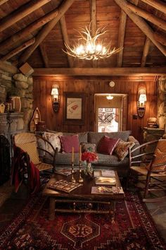 a living room filled with furniture and a chandelier hanging from the rafter