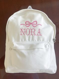 Baby Girl's First Bookbag! Name and thread color are customizable. White canvas book bag. Cute Canvas Bag For Back To School, Preppy White Bag For Back To School, Preppy White Bags For Back To School, Preppy White Back To School Bags, Preppy White Bags For School, Preppy White School Bag, Cute Pink Canvas Bag For School, White Canvas School Bag, White School Bags With Letter Embroidery