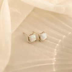 Introducing our Princess Cut Opal Studs, a vintage-inspired touch of elegance for your everyday look. With their classic princess cuts and enchanting opal stones, these earrings effortlessly add a hint of timeless charm to any outfit, making them perfect for both casual and special occasions. Material: High Quality Solid 925 Sterling Silver Finish: Sterling Silver ∙ 18K Gold Featuring elegant ~7x7mm square CZ Opal Stud Earrings Sold as a Pair Part of our Opal Collection Model showcases a chic ev Classic Opal Jewelry For Formal Occasions, Opal Earrings For Wedding, Elegant Hypoallergenic Opal Jewelry, Dainty Opal Earrings For Wedding, Classic White Birthstone Earrings, Minimalist Opal Earrings As Gift, Dainty Hypoallergenic Opal Earrings, Dainty White Opal Earrings, Minimalist Hypoallergenic Opal Earrings