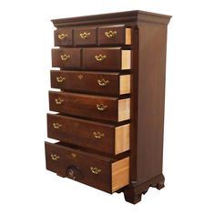 a wooden dresser with five drawers and gold handles