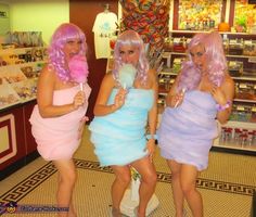 three women dressed in pink and blue posing for the camera