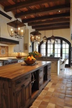 a large kitchen with an island in the middle and lots of lights hanging from the ceiling