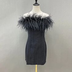 Beautiful raw edge black denim mini dress with ostrich feather trim. Make a statement with this fun feather trimmed dress! * Sizing - All items are made according to measurement ranges, they are NOT typical letter or numeric sizing. It is imperative to compare your exact measurements with the size chart provided either in the listing photos or item descriptions and to also add your measurements under Personalization. If you have any questions on sizing, please feel free to message me. Do not order your normal size without taking and comparing measurements. * EXCHANGES ONLY. Returns will not be accepted. I have explained the importance of adding your exact measurements under Personalization and/or sending them to me so that I can help with the proper sizing. I cannot be responsible if you d Ostrich Feather Trim, Fur Dress, Crystal Dress, Feather Tops, Womens Denim Dress, Sequin Jumpsuit, Feather Trim, Ostrich Feather, Denim Mini Dress