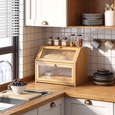 a kitchen counter with dishes on it and a wooden box in the middle that is filled with food