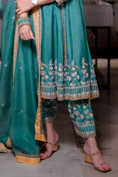 Teal blue raw silk kurta with resham embroidery. Comes with pearl embroidered pant. Paired with organza dupatta with embroidered border. 
Component: 3
Pattern: Embroidered
Type Of Work: Resham,pearl
Neckline: Round
Sleeve Type: Three quarter
Fabric: Raw silk, organza
Color: Blue
Other Details: 
Pearl embroidery
Mirror work
Attached lining
Occasion: Sangeet,Mehendi and Haldi - Aza Fashions Raw Silk Kurta, Embroidery Mirror, Resham Embroidery, Kurta Set For Women, Pearl Embroidery, Embroidered Pants, Silk Kurta, Embroidered Border, Organza Dupatta