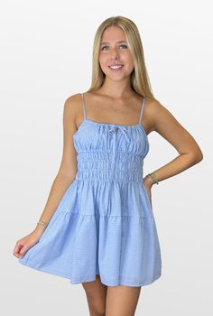 A story all its own. This adorable gingham dress is flattering and on-trend. The bodice is roomy at the bustline with a smocked waist that cinches in at the best place. The fully lined dress has adjustable spaghetti straps, and the full skirt completes the look. Color- Light Blue and White 100% Cotton Lining- 100% Polyester Spring Cotton Smocked Dress With Adjustable Straps, Plaid Smocked Dress For Summer Picnic, Gingham Sundress For Brunch, Ruched Gingham Dress For Brunch, Gingham Smocked Dress For Picnics, Plaid Smocked Dress For Summer Picnics, Summer Plaid Smocked Dress For Picnic, Casual Cotton Smocked Dress With Adjustable Straps, Casual Smocked Dress With Spaghetti Straps And Gathered Waist