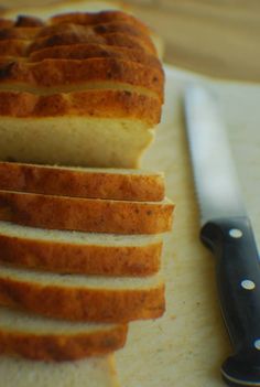 slices of bread sitting on top of a cutting board next to a knife