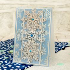 a card with snowflakes on it sitting on a table