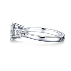 Set in a classic three-stone setting, this iconic ring features a stylish round cut Moissanite Diamond, two tapered baguette-cut diamonds set in classic bar channels, and a sleek metal band. Crafted in 925 Sterling Silver, this ring offers a petite silhouette with timeless style. Style ID: R210121SWLM0107Metal: S925 SilverMetal Color: WhiteAverage Width: 2mmRhodium Finish: YesStone(s): MoissaniteTotal Weight (CT. T.W.): 1.28ctCenter Stone T.W.: 1ctStone Dimension: 6.5mmStone Shape: RoundStone Co Classic Silver Moissanite Diamond Ring, Formal Three Stone Round Diamond Ring, Formal Three-stone Round Diamond Ring, Timeless Silver Diamond Ring With Baguette Cut, Classic Diamond Ring With Vs Clarity For Formal Occasions, Timeless Silver Moissanite Diamond Ring, Timeless Moissanite Silver Diamond Ring, Silver Diamond Ring With Baguette Cut, Timeless Silver Baguette Cut Diamond Ring